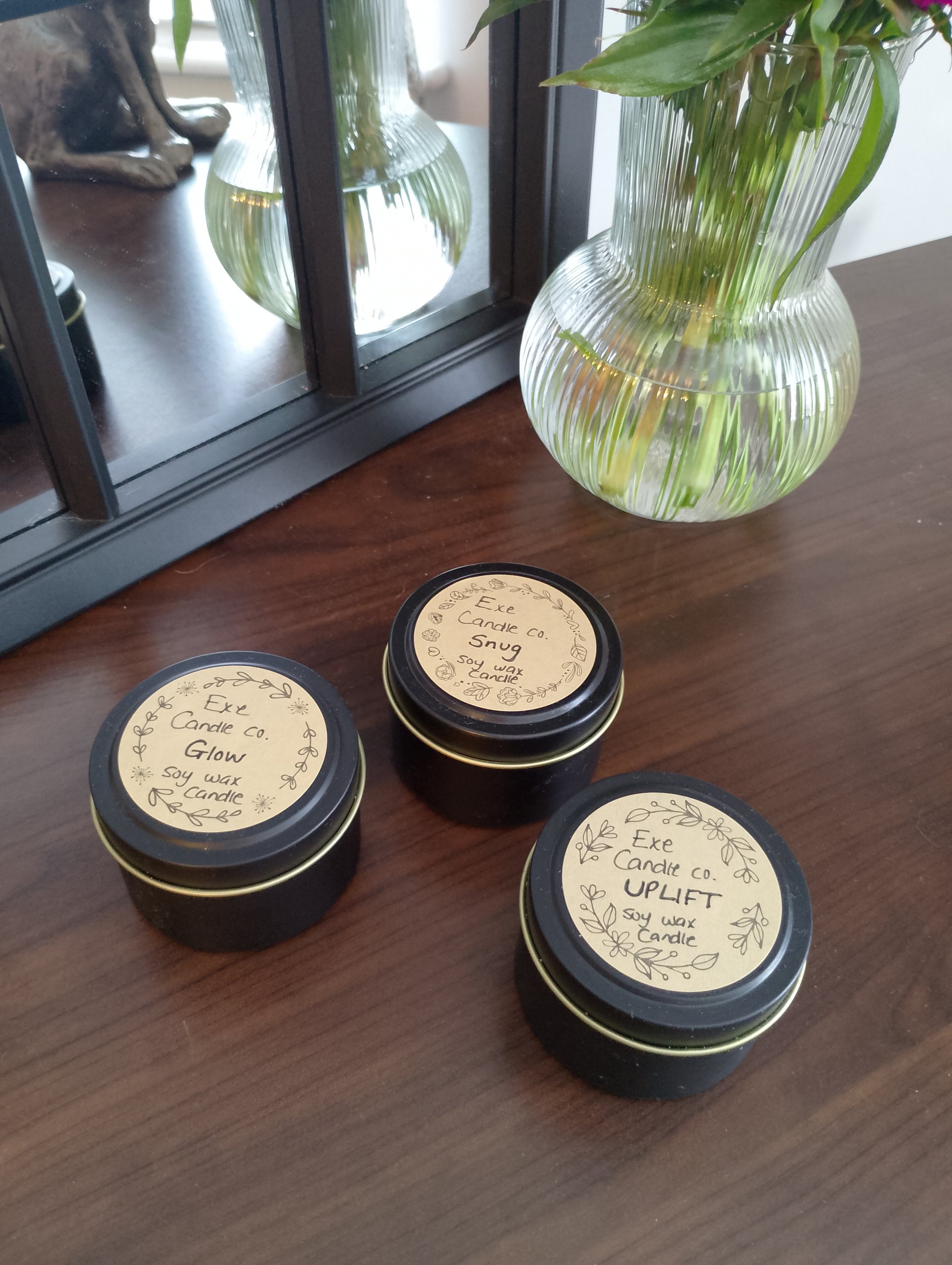 three scented candle tins together